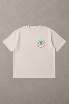 T-shirt oversize blanc De la Terre au Ciel, logo œil qui sourit multicolore, La Marelle Comedy Club Bordeaux